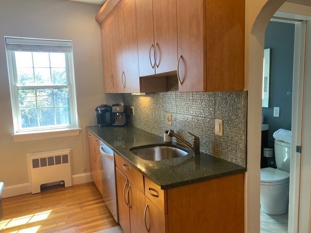 116 Floral Street, Unit 6 Newton, MA 02461 - Photo 8 of 12 a kitchen with a sink and a wooden cabinets