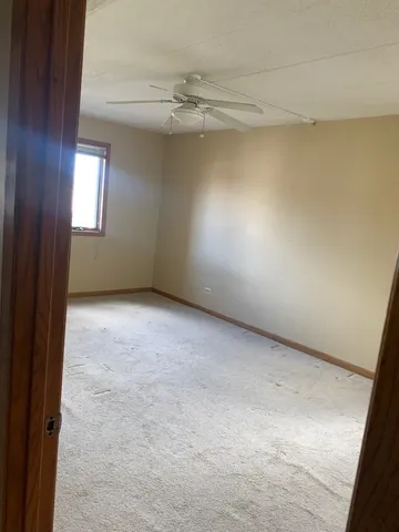 a room with water heater and wooden cabinets