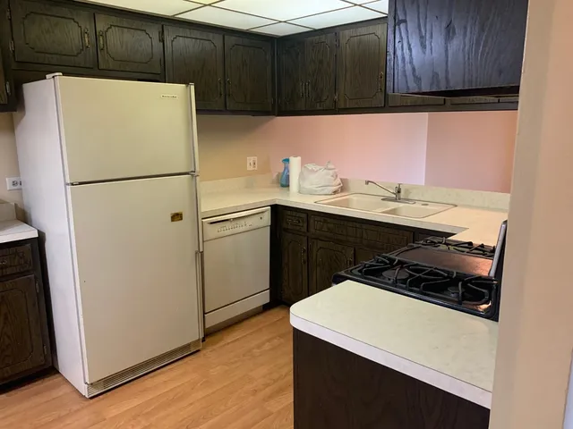 a white refrigerator freezer sitting in a kitchen