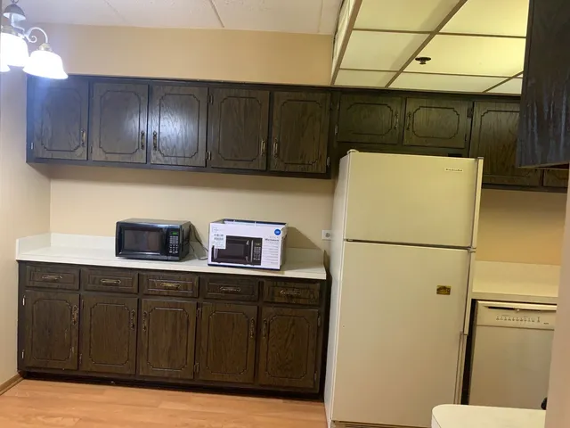 a kitchen with a refrigerator and cabinets