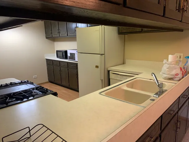 a stove top oven sitting inside of a kitchen