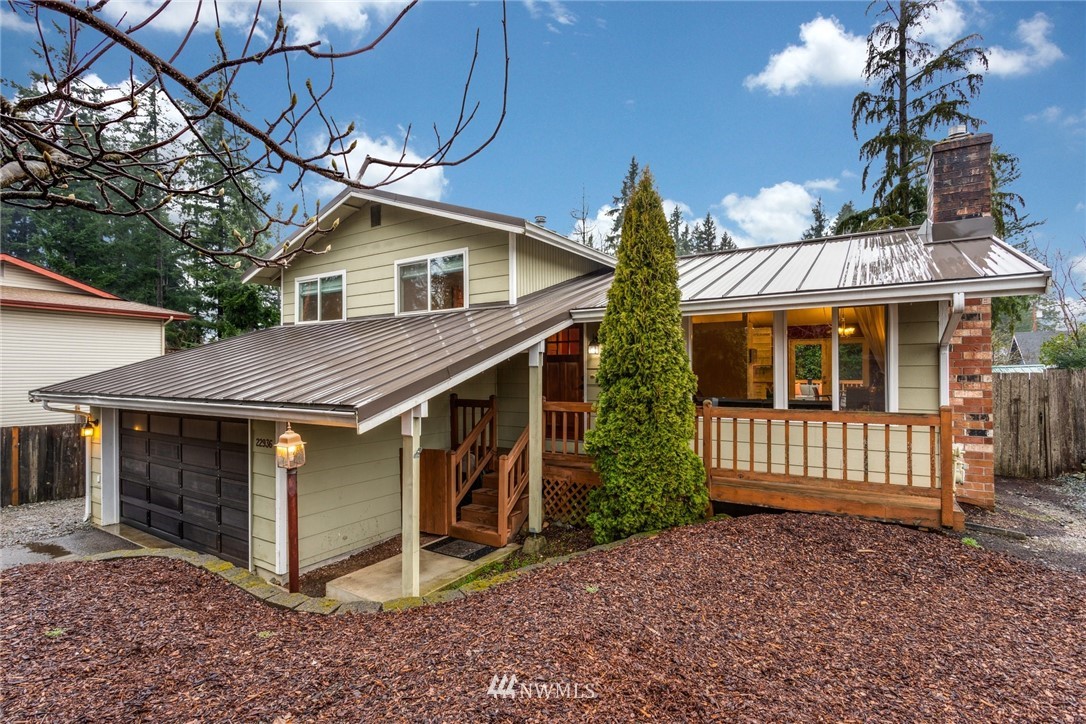 22936 Southeast 288th Street Maple Valley, WA 98038 - Photo 1 of 26 a front view of a house with garden