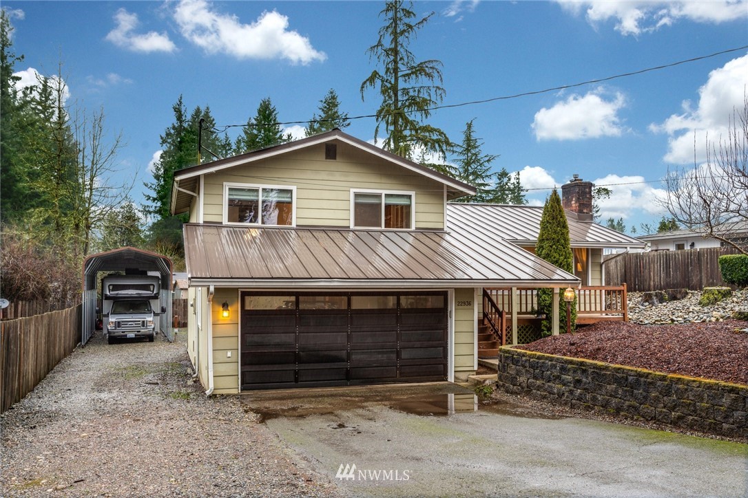 22936 Southeast 288th Street Maple Valley, WA 98038 - Photo 2 of 26 a front view of a house with a yard