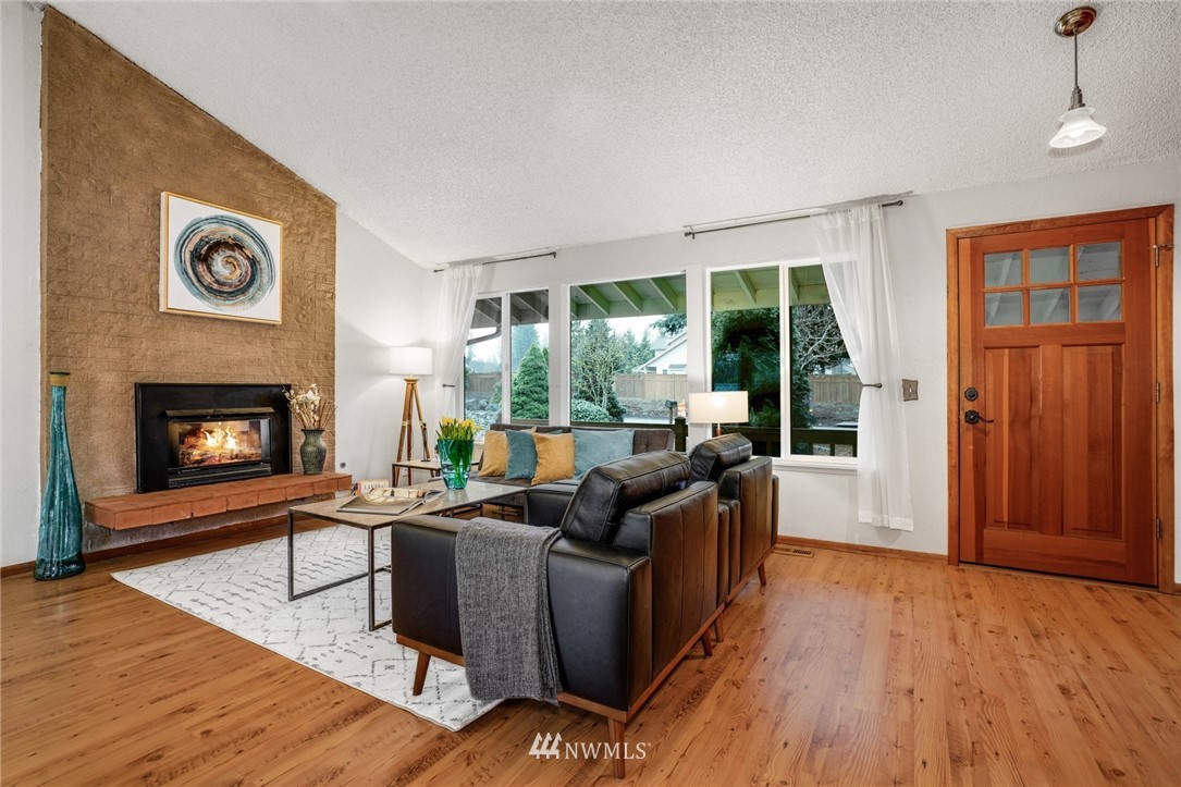 22936 Southeast 288th Street Maple Valley, WA 98038 - Photo 18 of 26 a living room with furniture and a fireplace
