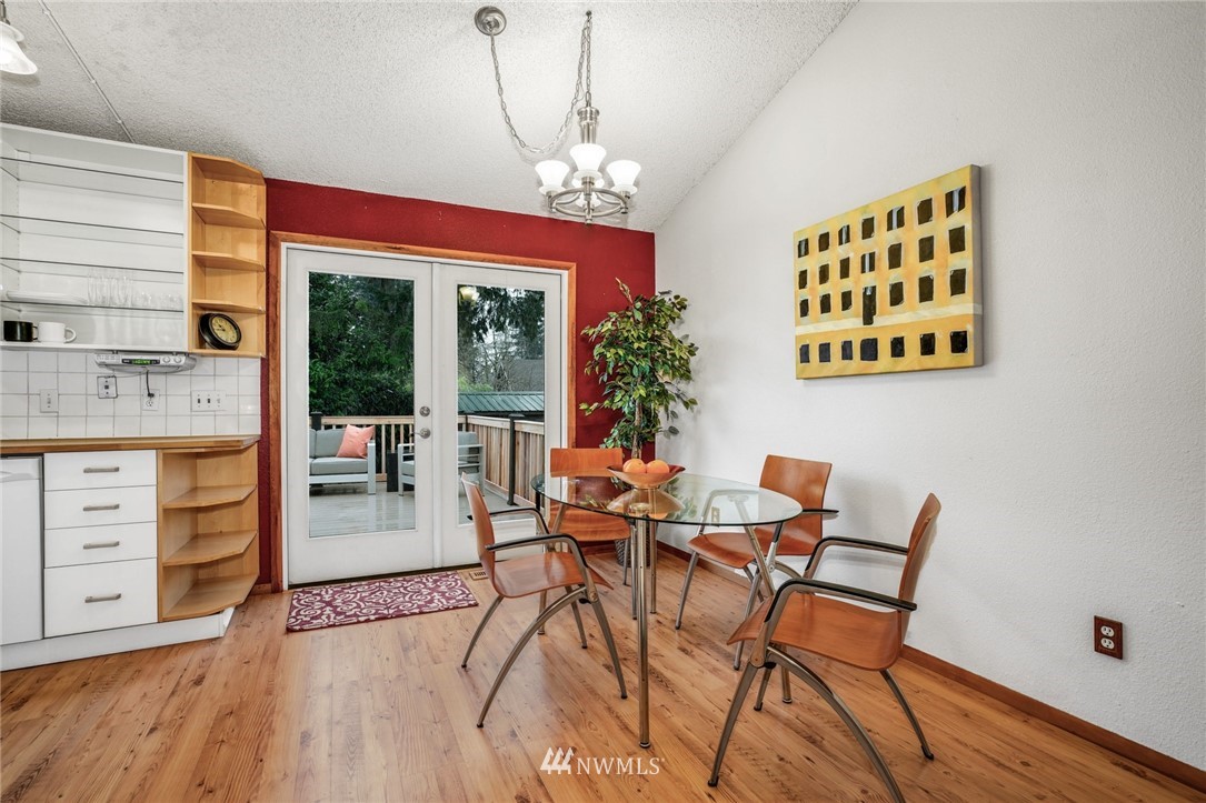 22936 Southeast 288th Street Maple Valley, WA 98038 - Photo 19 of 26 a view of a dining room with furniture window and wooden floor