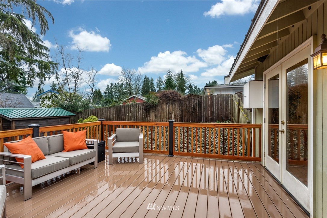 22936 Southeast 288th Street Maple Valley, WA 98038 - Photo 22 of 26 a balcony with outdoor seating and wooden floor
