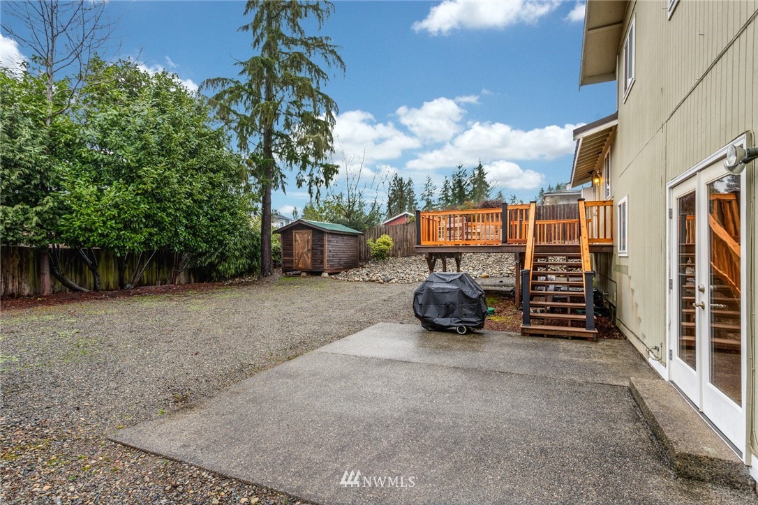 22936 Southeast 288th Street Maple Valley, WA 98038 - Photo 23 of 26 a view of a street with cars parked in front of a house