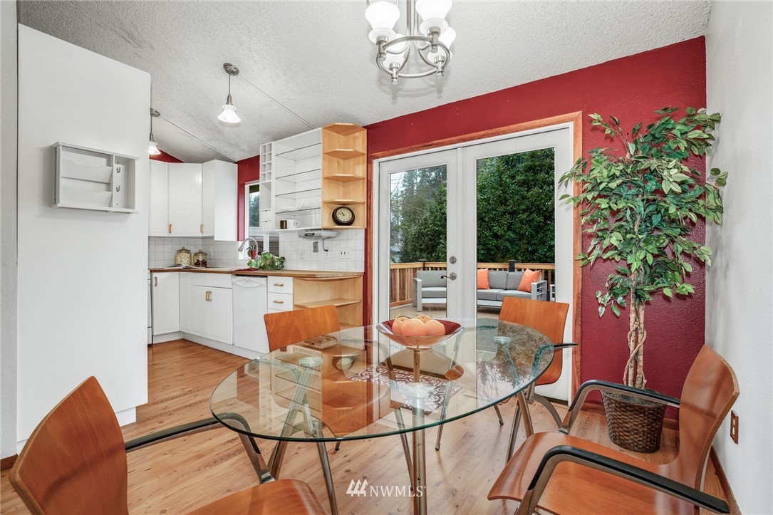 22936 Southeast 288th Street Maple Valley, WA 98038 - Photo 5 of 26 a dining room with furniture a potted plant and a chandelier