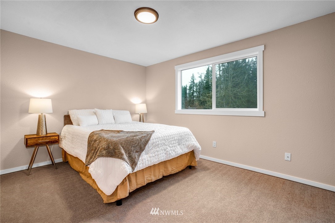 22936 Southeast 288th Street Maple Valley, WA 98038 - Photo 7 of 26 a bedroom with a bed and a lamp