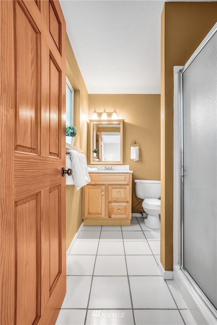 22936 Southeast 288th Street Maple Valley, WA 98038 - Photo 8 of 26 a bathroom with a toilet a sink and mirror