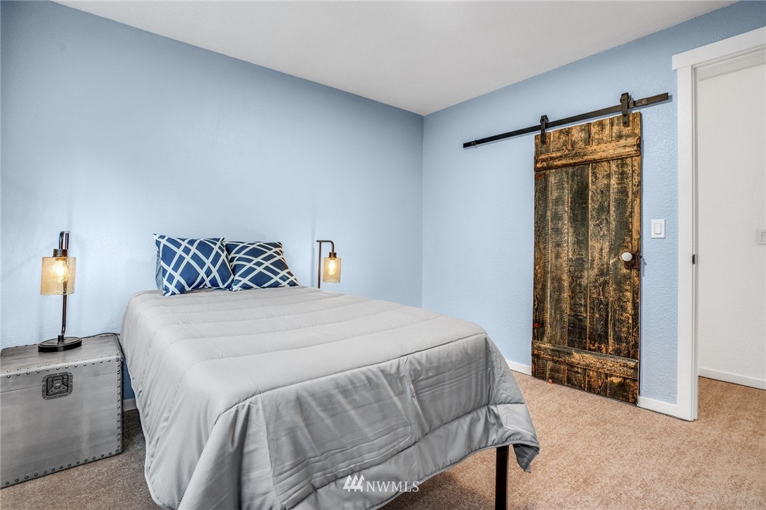 22936 Southeast 288th Street Maple Valley, WA 98038 - Photo 9 of 26 a bedroom with a bed and a window