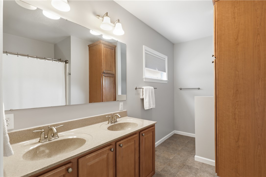 5791 Joy Road Conesus, NY 14435 - Photo 19 of 48 Primary bathroom with dual-sink vanity and sleek finishes.