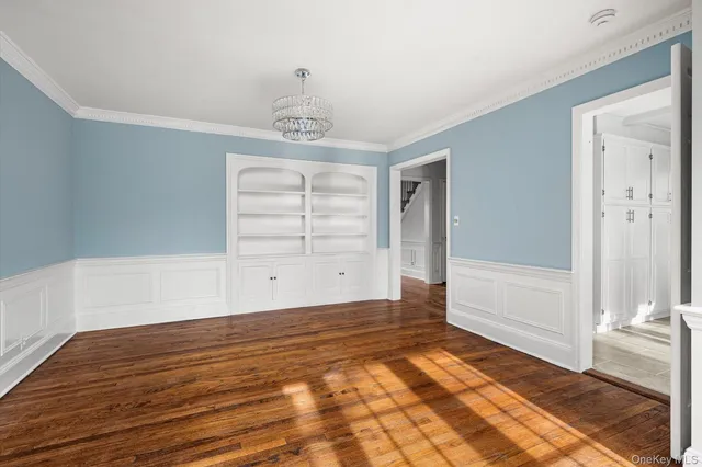 a bedroom with two beds and painting on the wall