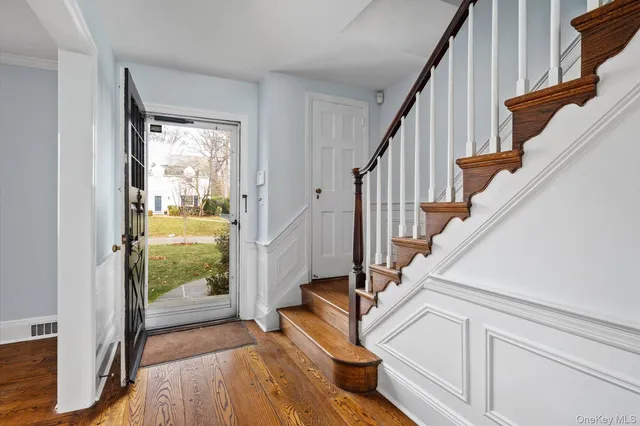 a view of a livingroom with wooden floor and a fireplace