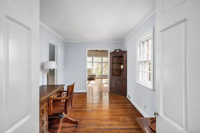 a living room with furniture floor to ceiling window and a flat screen tv