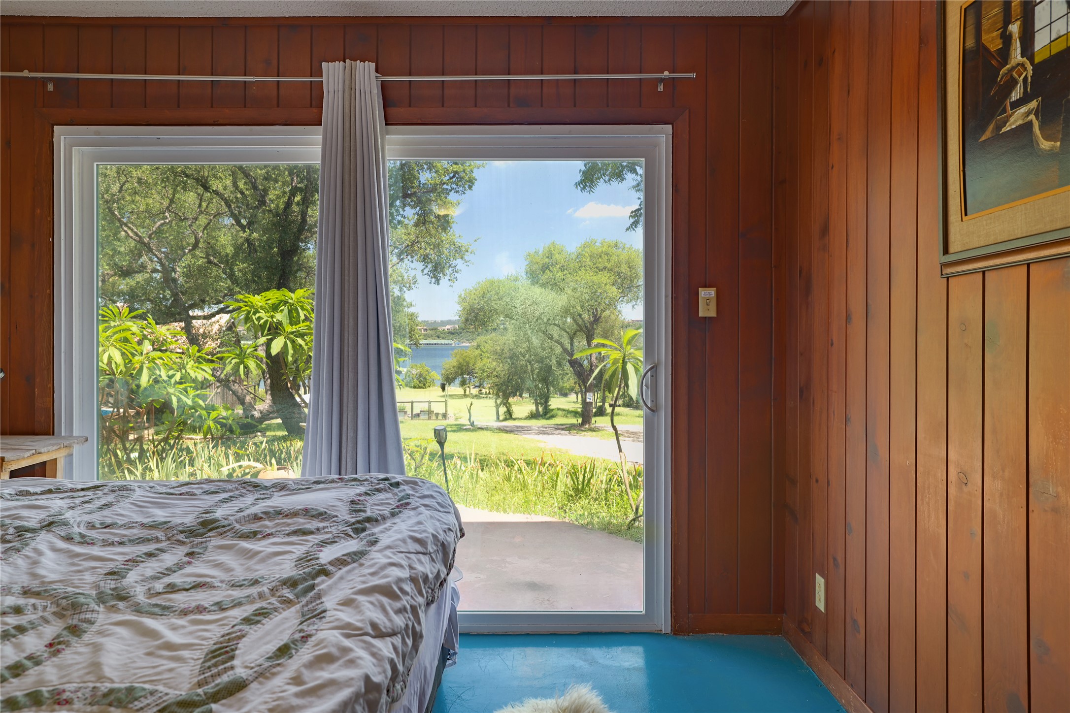 16800 Forest Way Austin, TX 78734 - Photo 13 of 15 A tranquil lakeside retreat awaits, featuring wide sliding doors that invite natural light and scenic views into this inviting space.