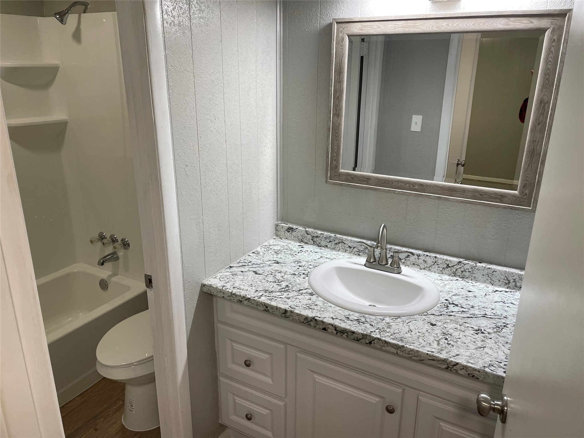 1209 Vance Street, Unit 45 Taylor, TX 76574 - Photo 13 of 32 Full bath featuring vanity, shower / bathtub combination, and wood finished floors