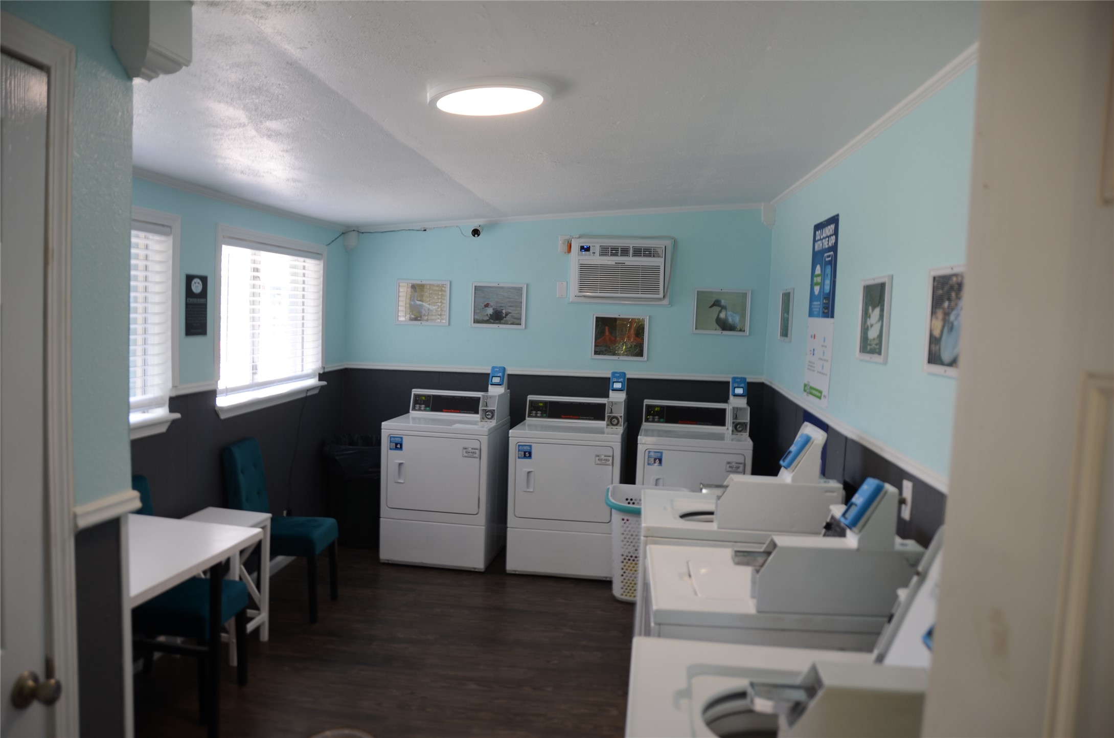 1209 Vance Street, Unit 45 Taylor, TX 76574 - Photo 24 of 32 Community laundry featuring crown molding, washer and dryer, a wainscoted wall, vaulted ceiling, and an AC wall unit