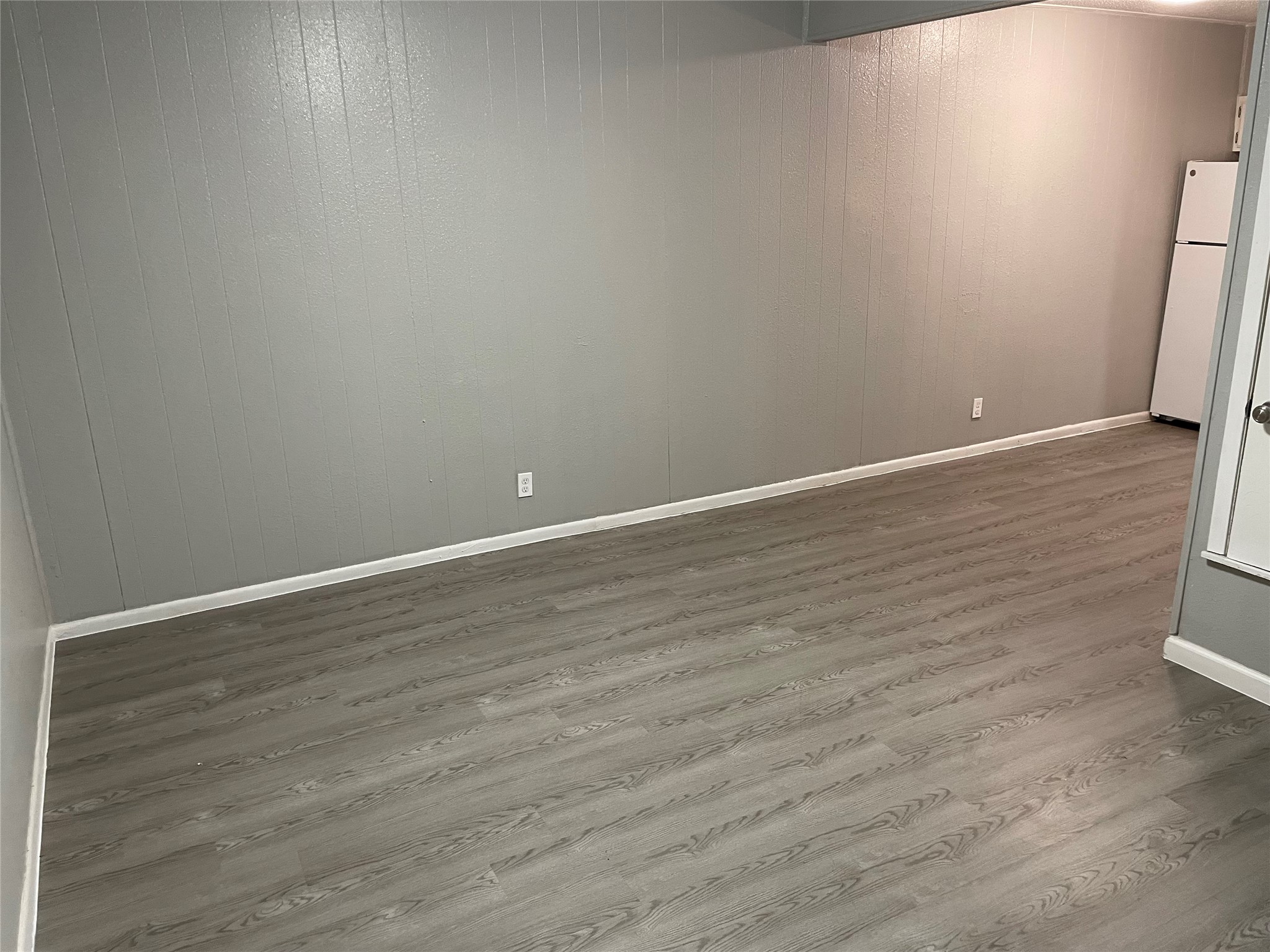 1209 Vance Street, Unit 45 Taylor, TX 76574 - Photo 27 of 32 Spare room with wooden walls and wood finished floors