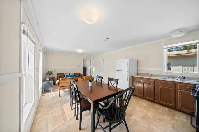 a view of a dining room with furniture and a kitchen