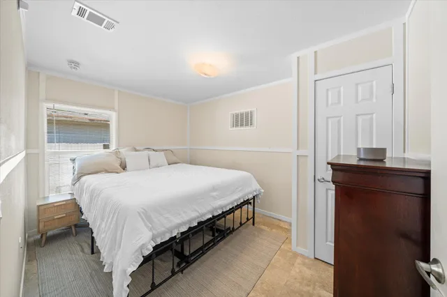 a bedroom with a bed and a closet