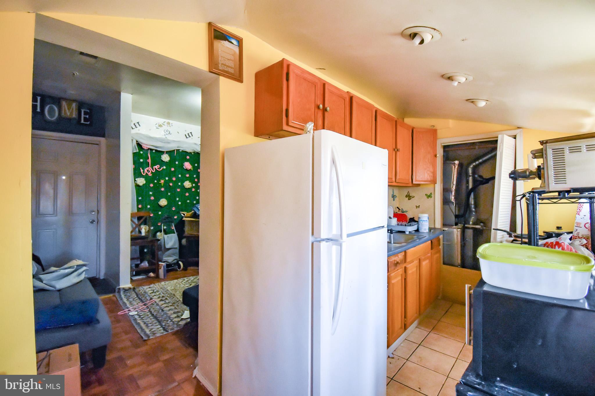 1921 Rhode Island Avenue Northeast Washington, DC 20018 - Photo 13 of 23 a kitchen with refrigerator a washer and dryer