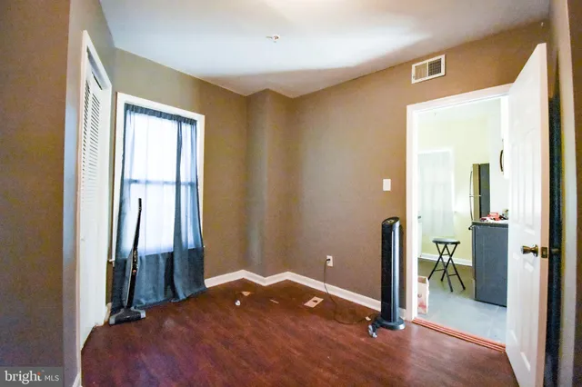 a view of a room that has a bed and a large mirror in it