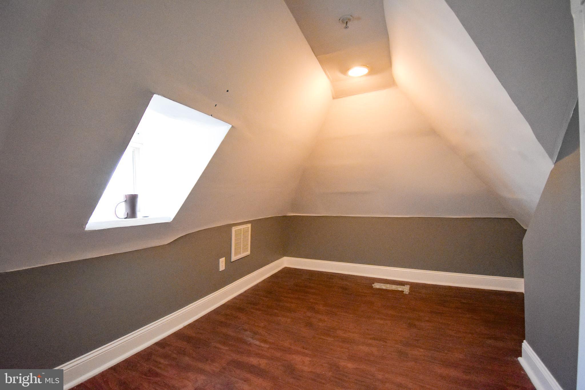 1921 Rhode Island Avenue Northeast Washington, DC 20018 - Photo 20 of 23 a view of an empty room with wooden floor