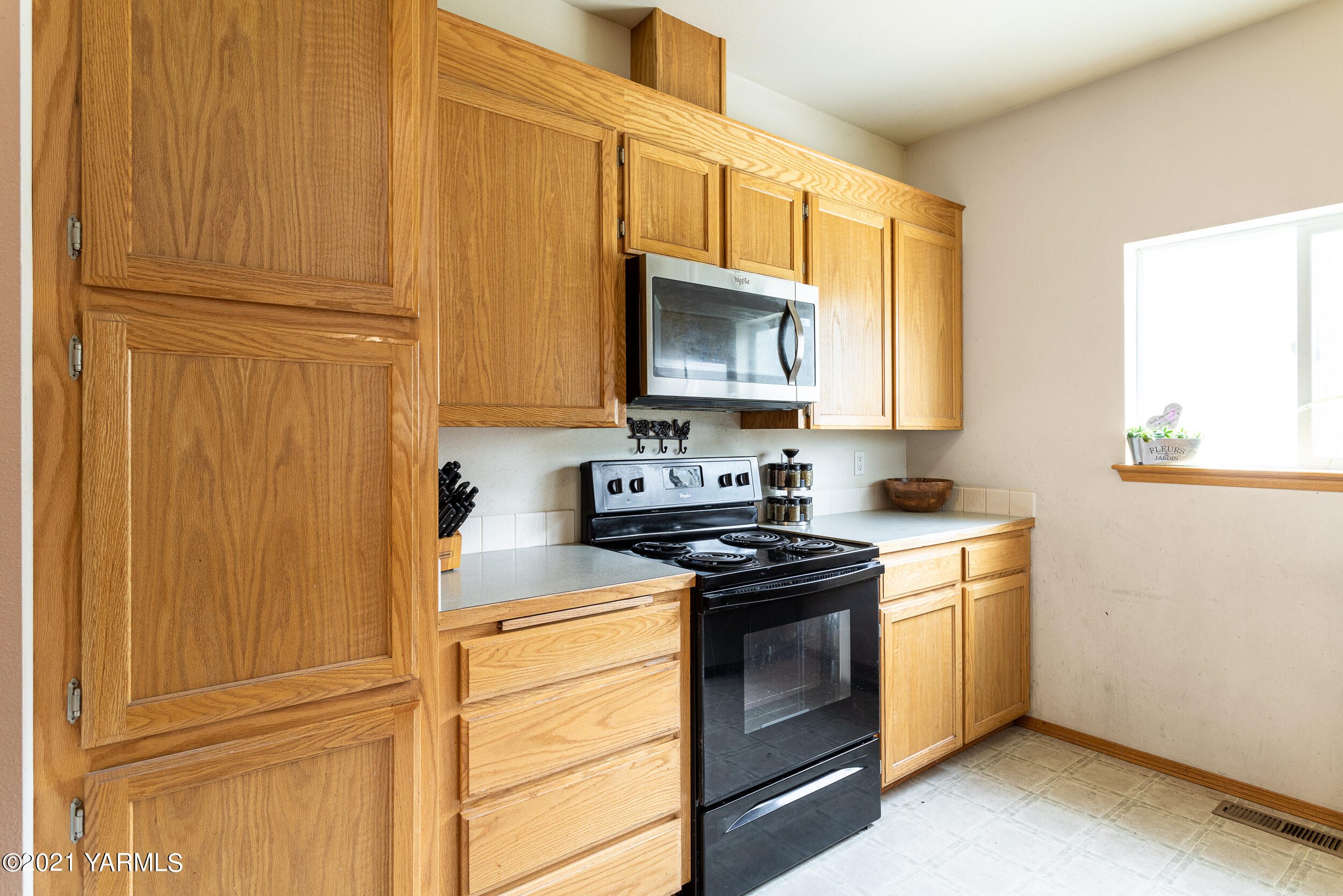 391 Sheep Company Road Selah, WA 98942 - Photo 11 of 26 a kitchen with stainless steel appliances granite countertop white cabinets stove a granite counter top and a microwave