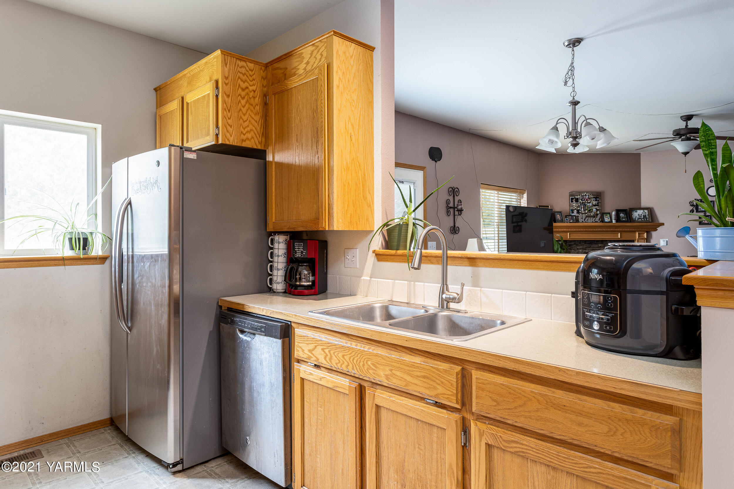 391 Sheep Company Road Selah, WA 98942 - Photo 12 of 26 a kitchen with stainless steel appliances granite countertop a sink a stove and a refrigerator