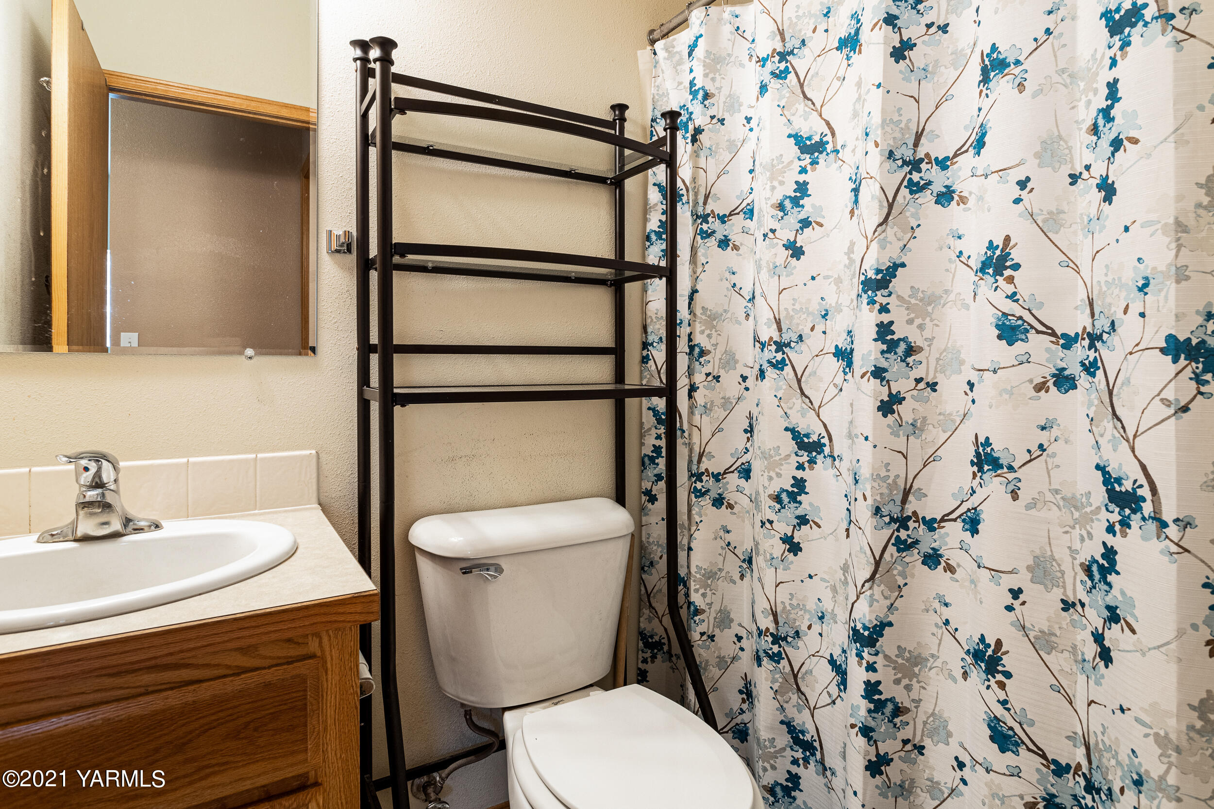 391 Sheep Company Road Selah, WA 98942 - Photo 13 of 26 a white toilet sitting next to a bathroom sink