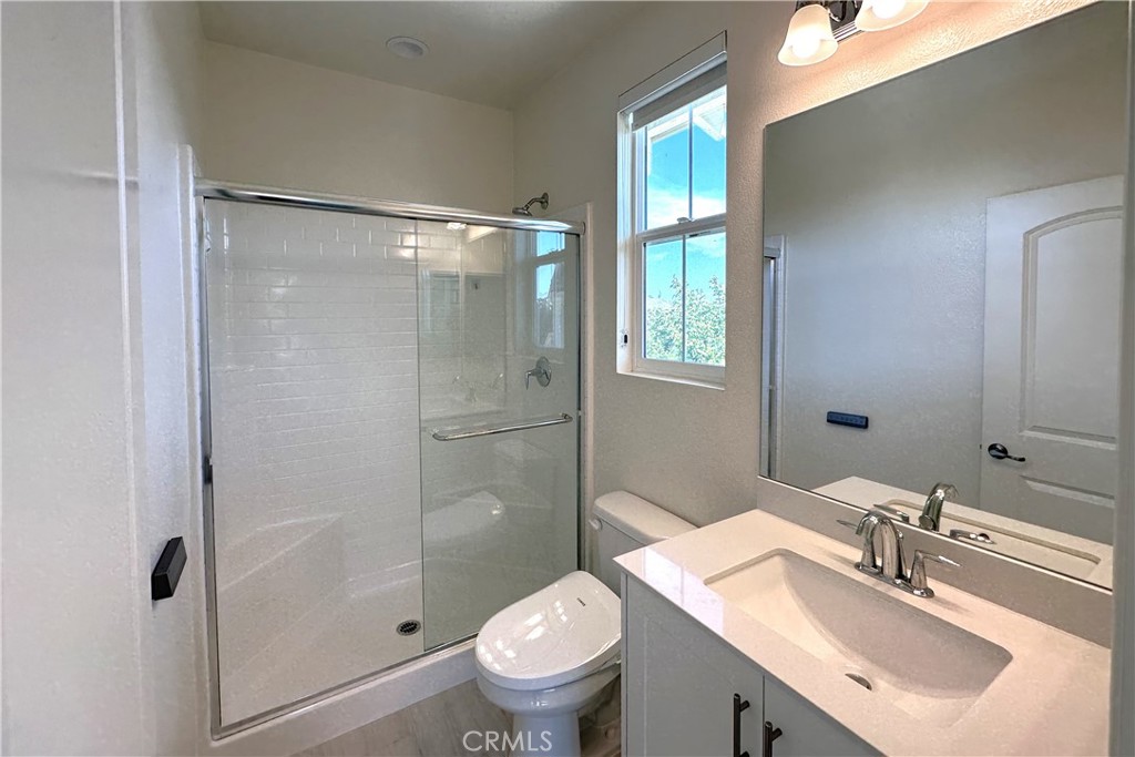 9318 Hellman Avenue, Unit 4 Rancho Cucamonga, CA 91730 - Photo 21 of 28 a bathroom with a sink toilet and shower