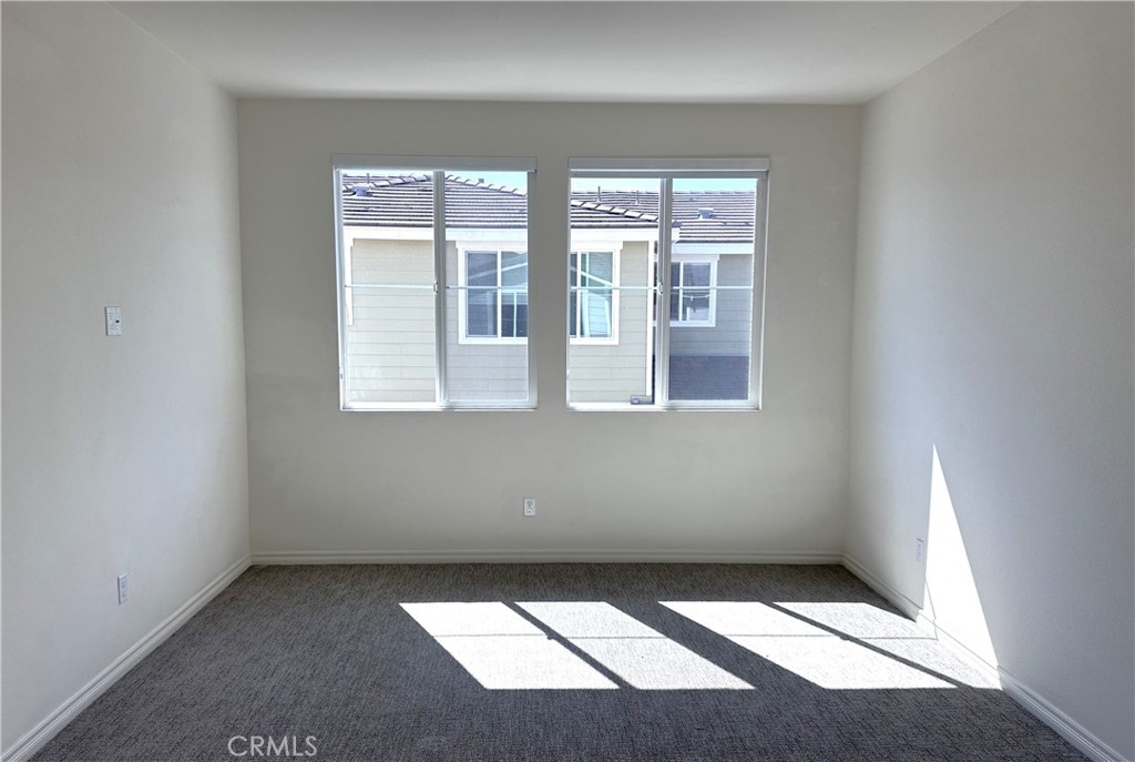 9318 Hellman Avenue, Unit 4 Rancho Cucamonga, CA 91730 - Photo 22 of 28 an empty room with windows
