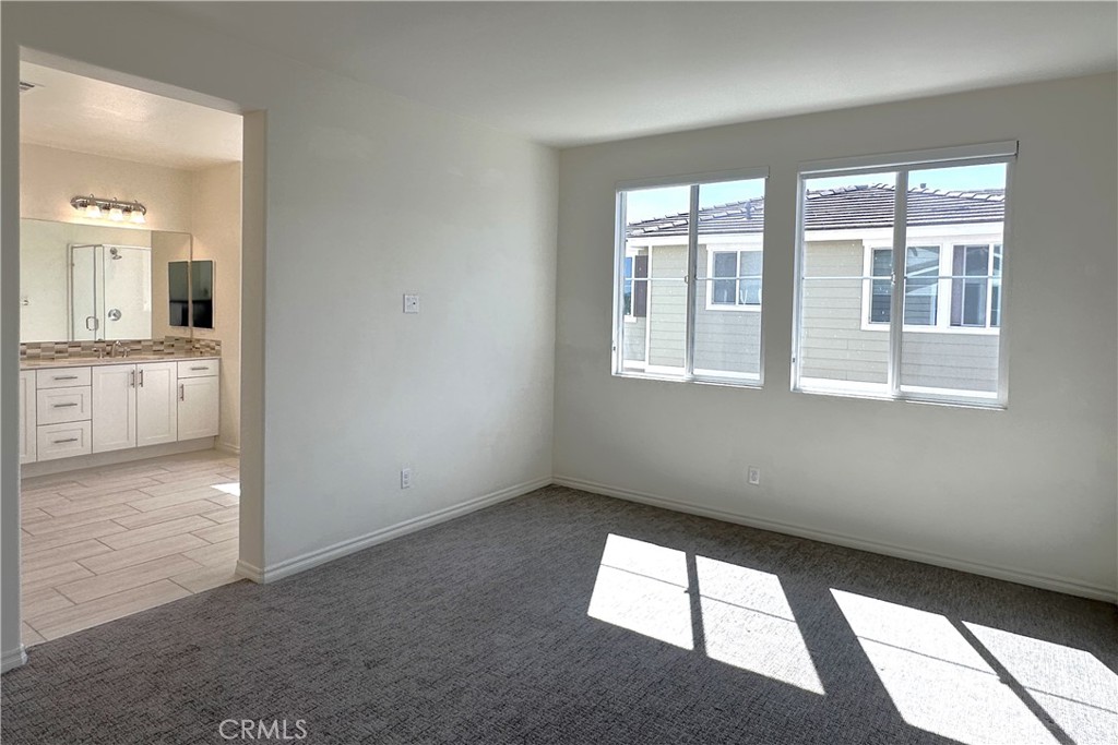 9318 Hellman Avenue, Unit 4 Rancho Cucamonga, CA 91730 - Photo 23 of 28 an empty room with windows