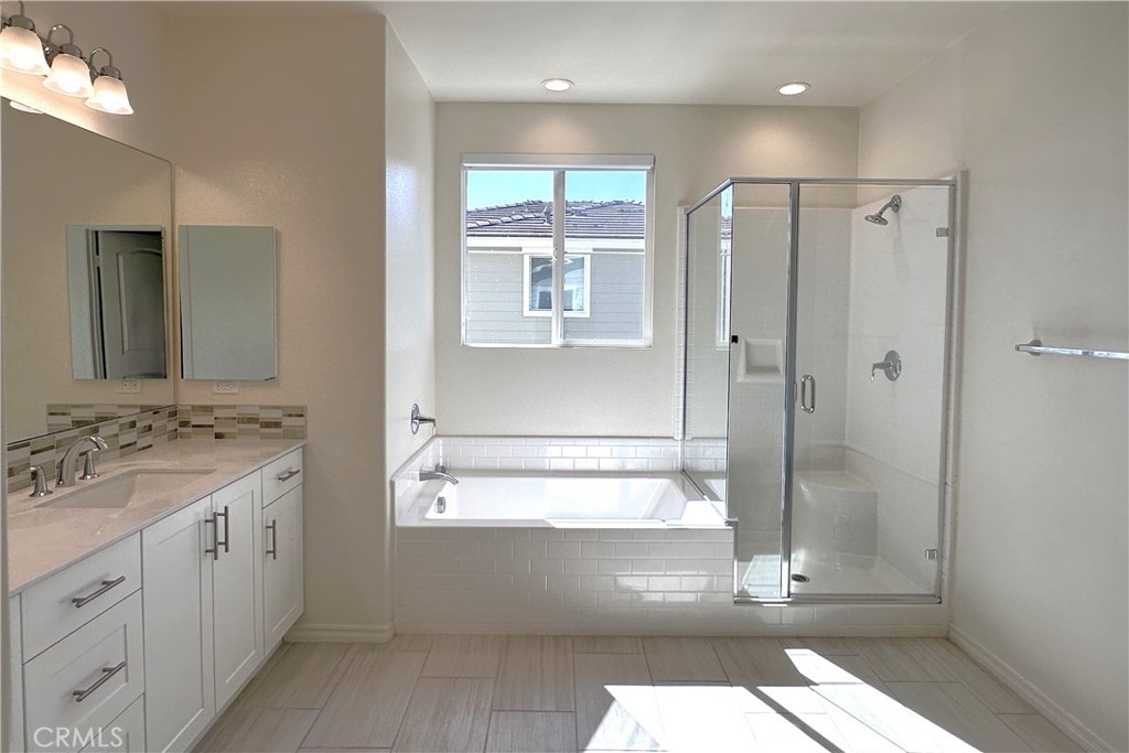 9318 Hellman Avenue, Unit 4 Rancho Cucamonga, CA 91730 - Photo 28 of 28 a bathroom with a shower sink and mirror