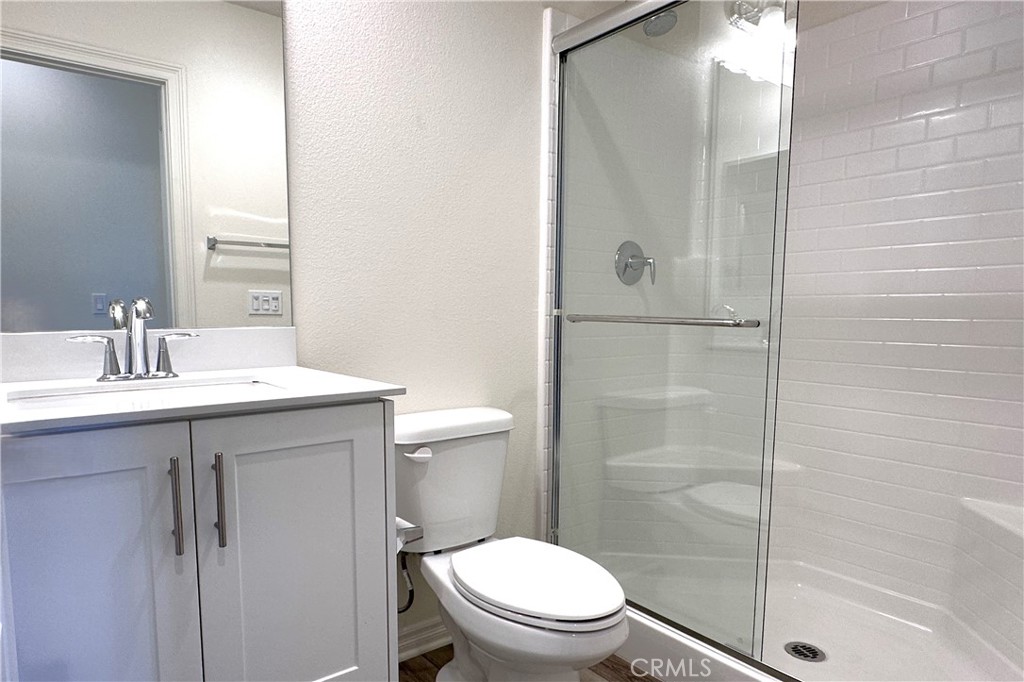 9318 Hellman Avenue, Unit 4 Rancho Cucamonga, CA 91730 - Photo 7 of 28 a bathroom with a sink a toilet and shower