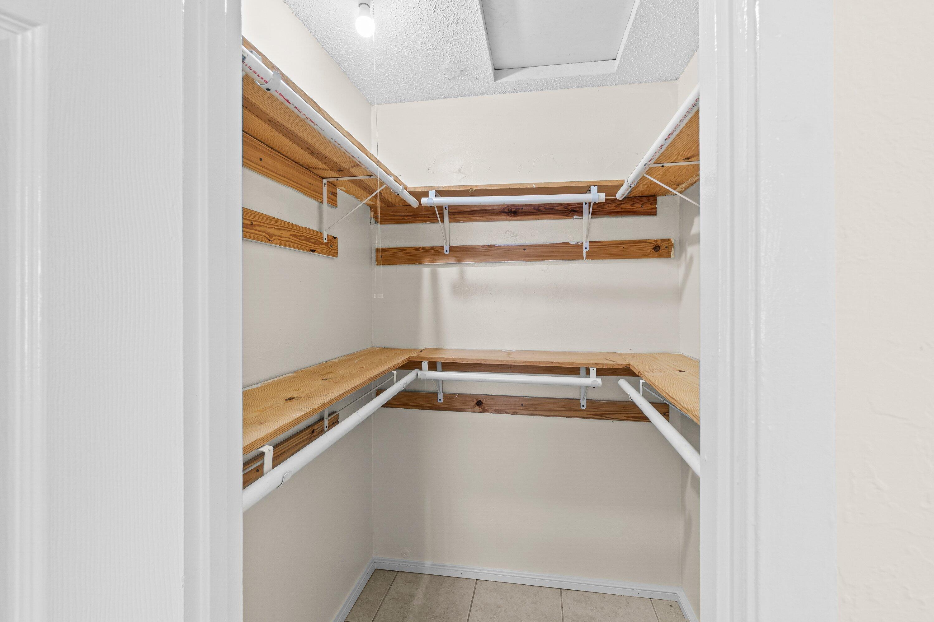 4869 Gulfstream Road Lake Worth, FL 33461 - Photo 15 of 20 a view of storage and utility room with racks on the wall