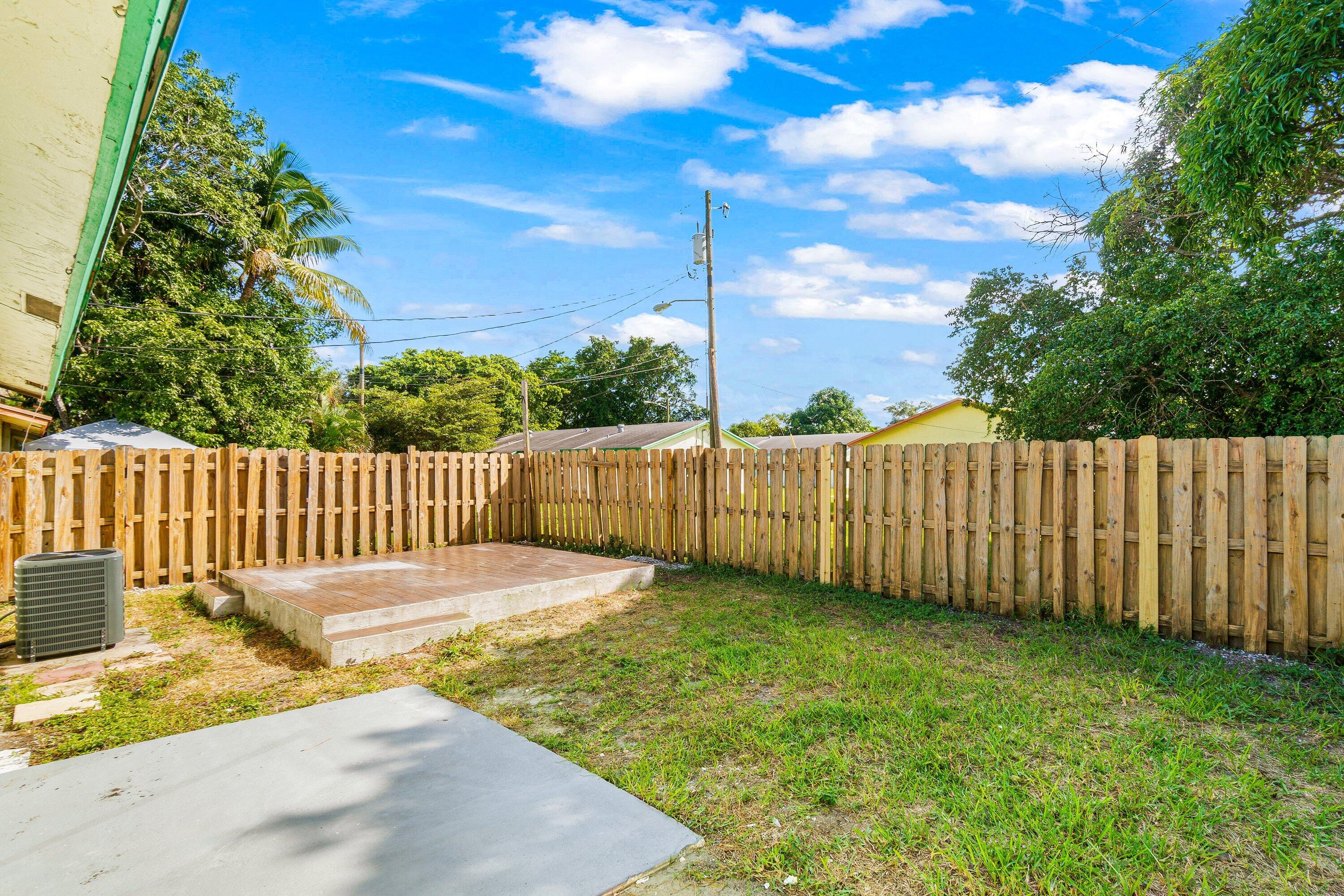 4869 Gulfstream Road Lake Worth, FL 33461 - Photo 18 of 20 a view of a backyard with fence