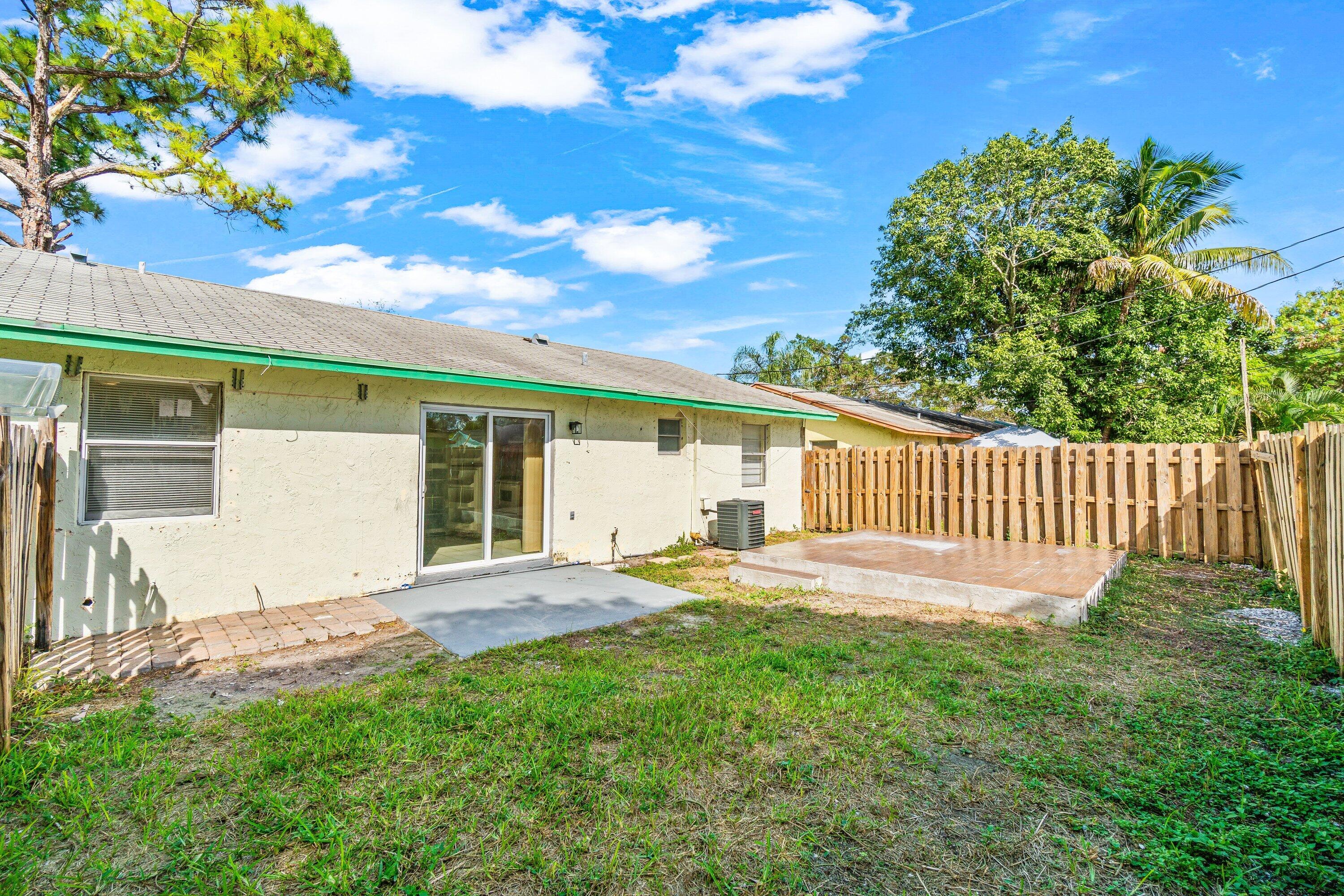 4869 Gulfstream Road Lake Worth, FL 33461 - Photo 19 of 20 a view of a house with a yard and sitting area
