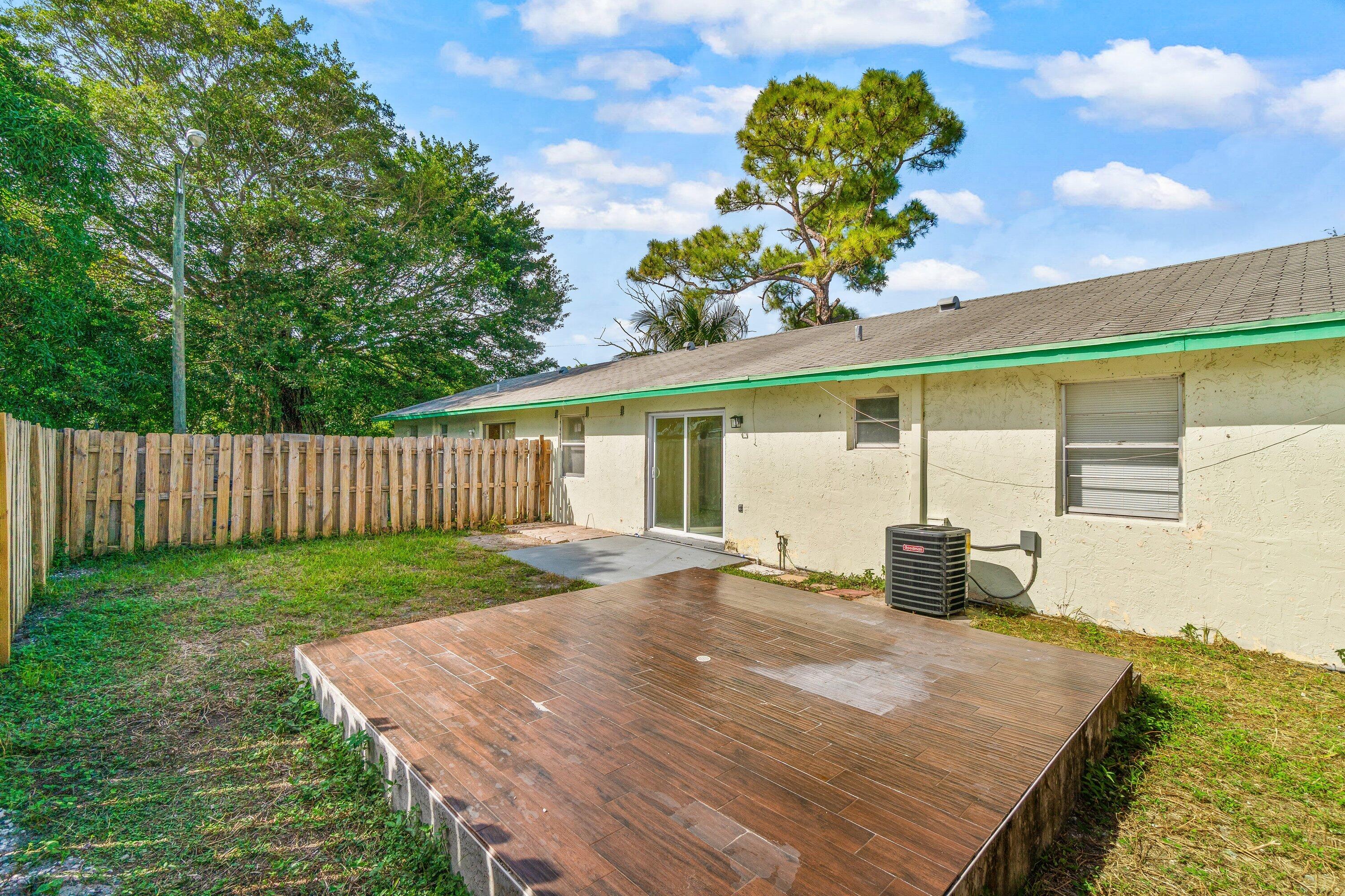 4869 Gulfstream Road Lake Worth, FL 33461 - Photo 20 of 20 a front view of a house with a garden