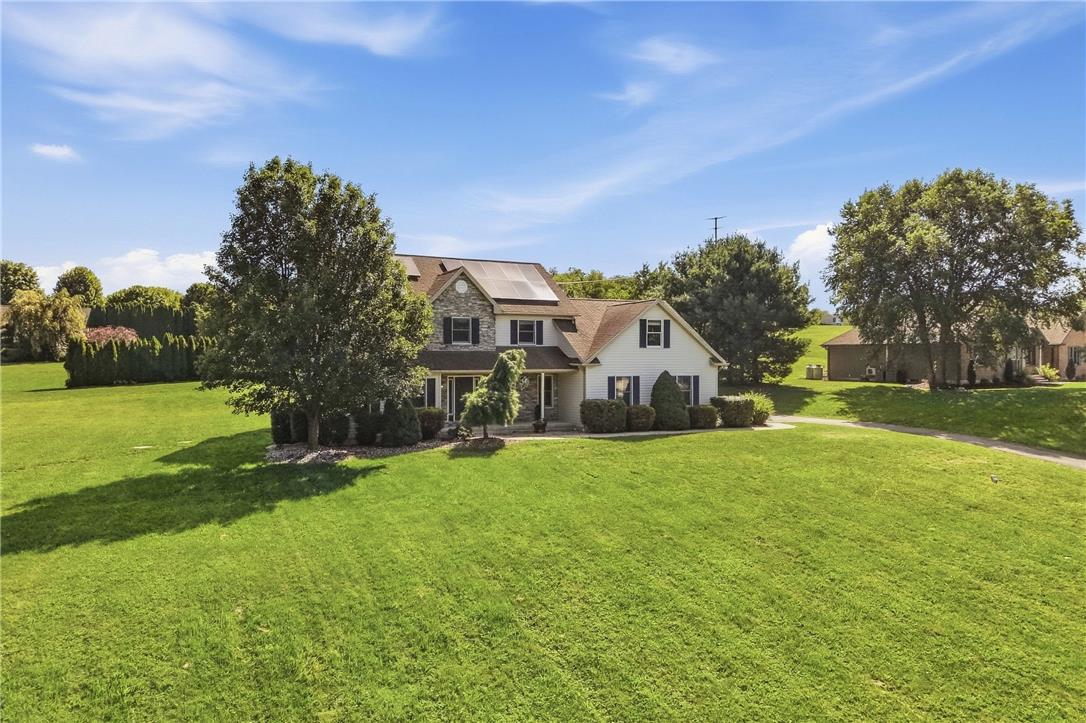 590 Fehr Road Nazareth, PA 18064 - Photo 2 of 79 Mature trees frame a classic multistory home surrounded by an expansive green lawn.