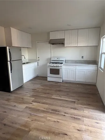 a kitchen with a stove and a refrigerator