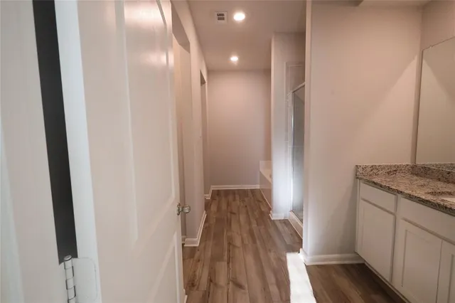 a view of hallway with wooden floor