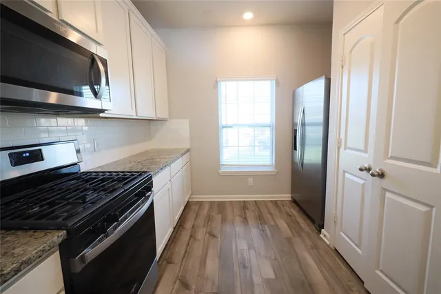 a kitchen with wooden floors and a stove top oven