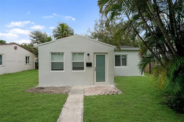 a front view of a house with a garden