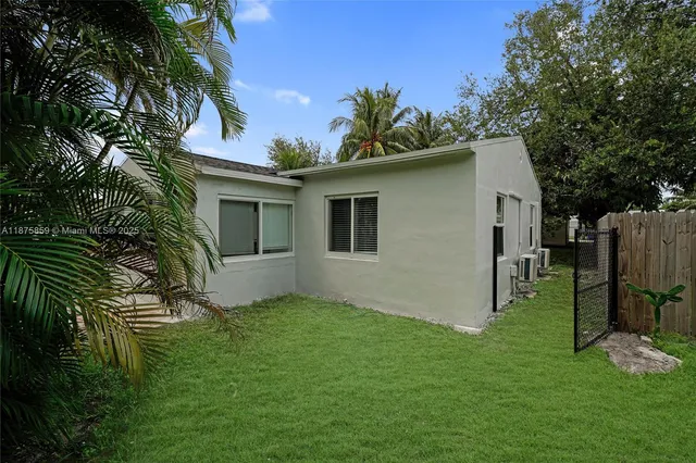 a backyard of a house with table and chairs