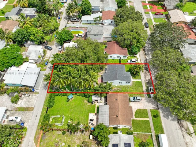 an aerial view of residential houses with outdoor space and street view