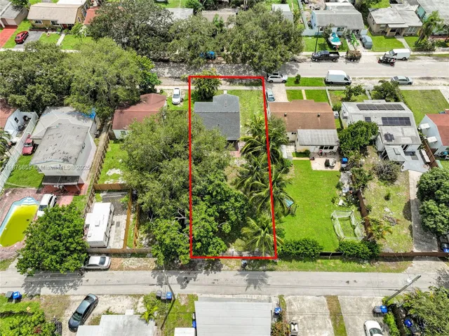 an aerial view of a house with a garden and lake view