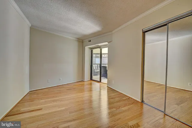 a view of an empty room with glass door