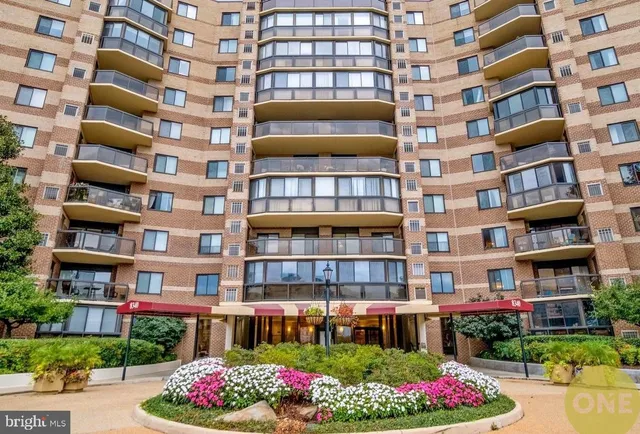 a front view of a building with a garden